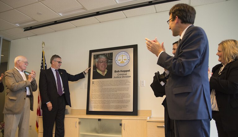 A plaque is hung following the renaming of the Washington State Attorney General’s Criminal Justice Division as the Bob Keppel Criminal Justice Division in September 2017.