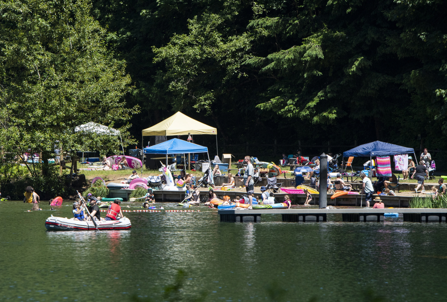 A crowd soaks up the sunshine on the shores of Battle Ground Lake on Saturday at Battle Ground Lake State Park.