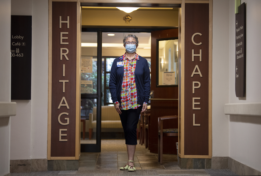 Marci Rau, who served as a chaplain at PeaceHealth Southwest Medical Center in Vancouver during the pandemic, pauses in the hospital's chapel. During the pandemic, Rau has had to find unique ways to connect patients and families during the dying process.