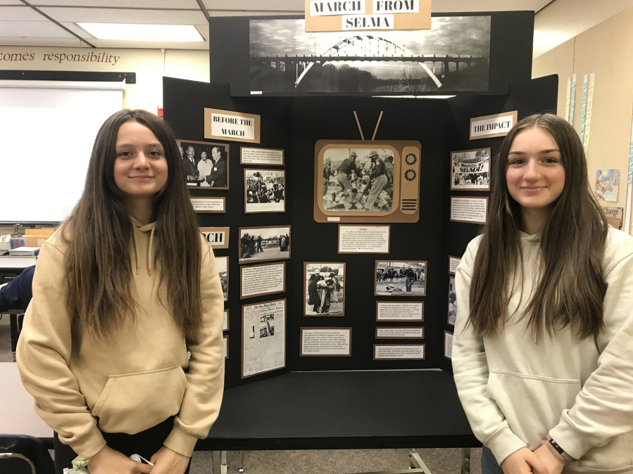 BATTLE GROUND: Pleasant Valley Middle School students Kristina Goldinov (left) and Abby Dubinskiy pose with their National History Day exhibit on the march from Selma to Montgomery, Ala.