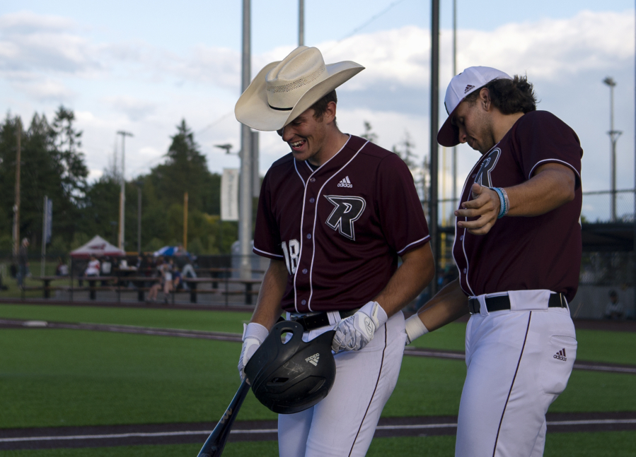 Ridgefield's Koby Darcy gets a cowboy hat and a pat on the butt from Coby Morales after hitting a solo home run in the second inning of a West Coast League baseball game on Tuesday, June 8, 2021, at the Ridgefield Outdoor Recration Complex. Ridgefield won 6-3 to improve to 4-0 on the season.