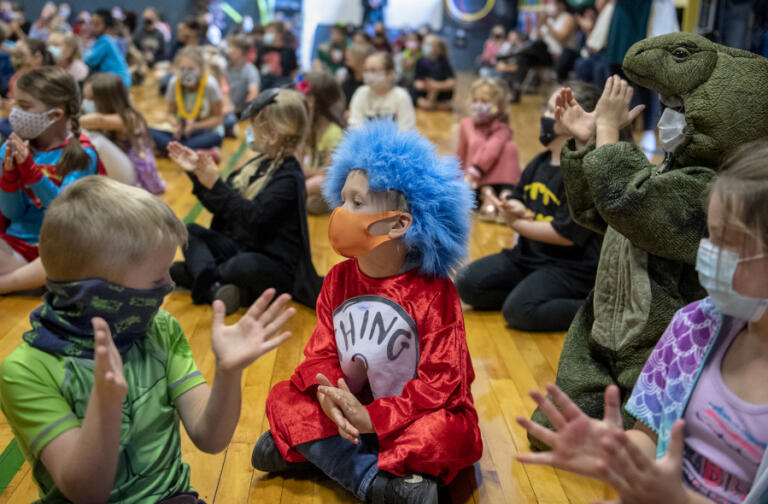 Kindergartners, dressed as their favorite superhero, join schoolmates in a round of applause for outgoing staff during an end-of-the-year assembly in the gym at Green Mountain School on Tuesday morning.