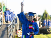 Associate in Arts graduate Alejandro Tapia-Garcia triumphantly holds up his diploma to a crowd watching outside the fence of Kim Christiansen Field on Thursday during the Clark College Commencement ceremony.