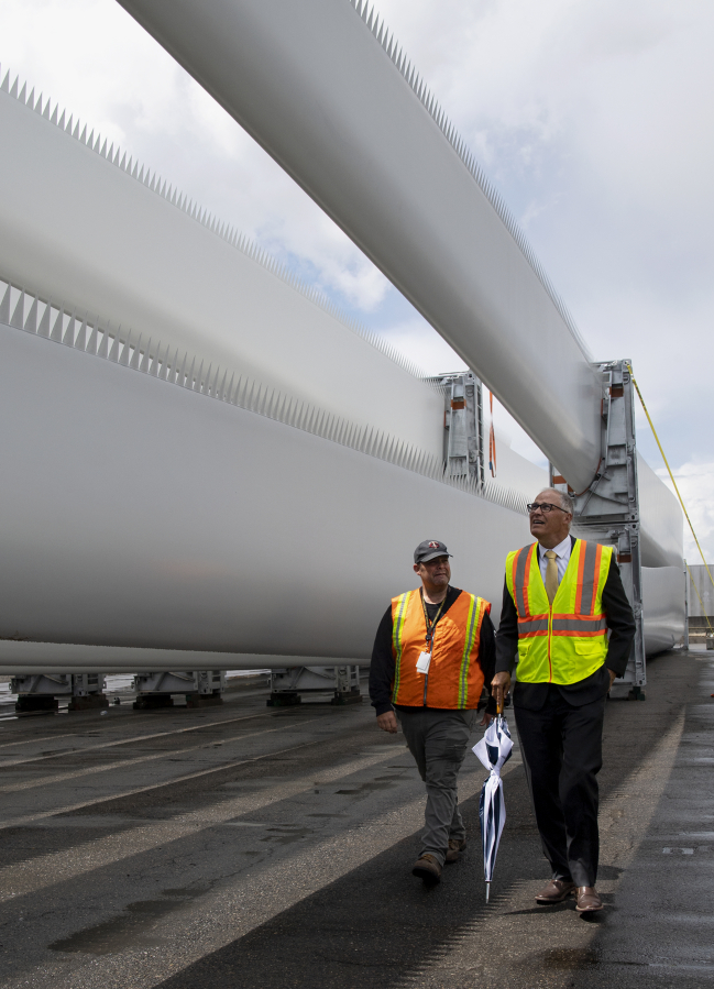 ILWU Local 4 President Cager Clabaugh walks alongside Gov. Jay Inslee as they tour a shipment of wind turbine blades at the Port of Vancouver on Tuesday.