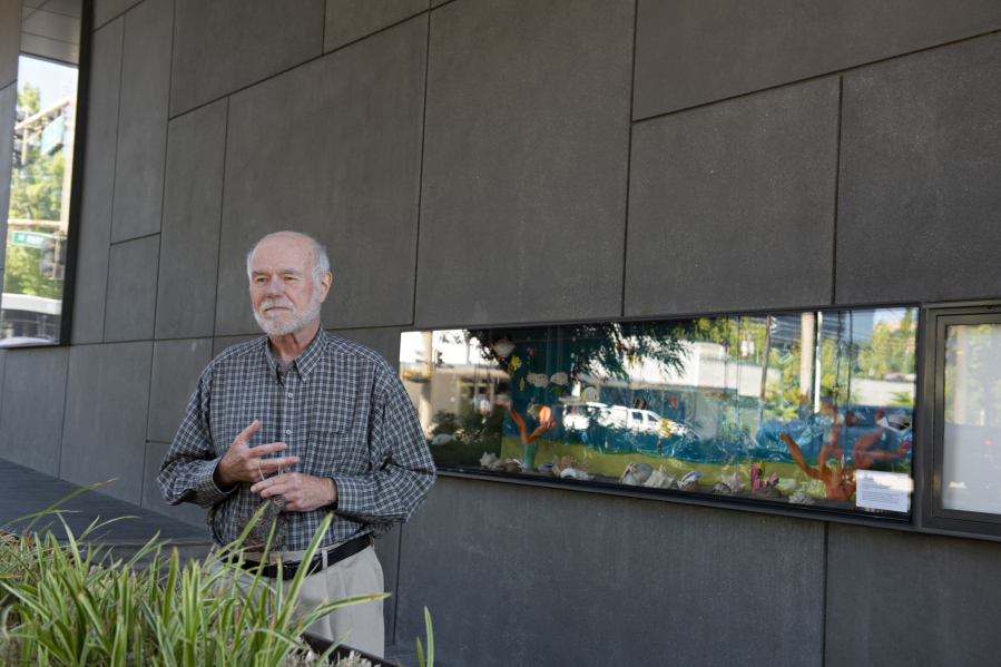 Artist Jeff Hill shows off the "fish tank," full of his papier-mâché tropical fish, that's on display outside the Vancouver Community Library. The fish stop swimming at the end of this month, but a similar papier-mâché butterfly exhibit is on display inside the building through July.