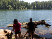 Chloe, 10, left, and Van Hoots, 12, of Salmon Creek, stand on the shores of Battle Ground Lake to fish on Saturday at Battle Ground Lake State Park.