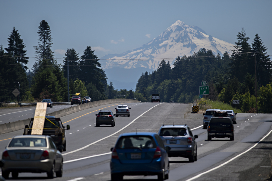 Drivers traveling east on state Highway 14 take in a scenic view as a snowcapped Mount Hood is seen in the distance under sunny skies Thursday. Forecasters expect sunny skies and summer-like temperatures for several days, with temperatures peaking near  100 degrees on Monday.