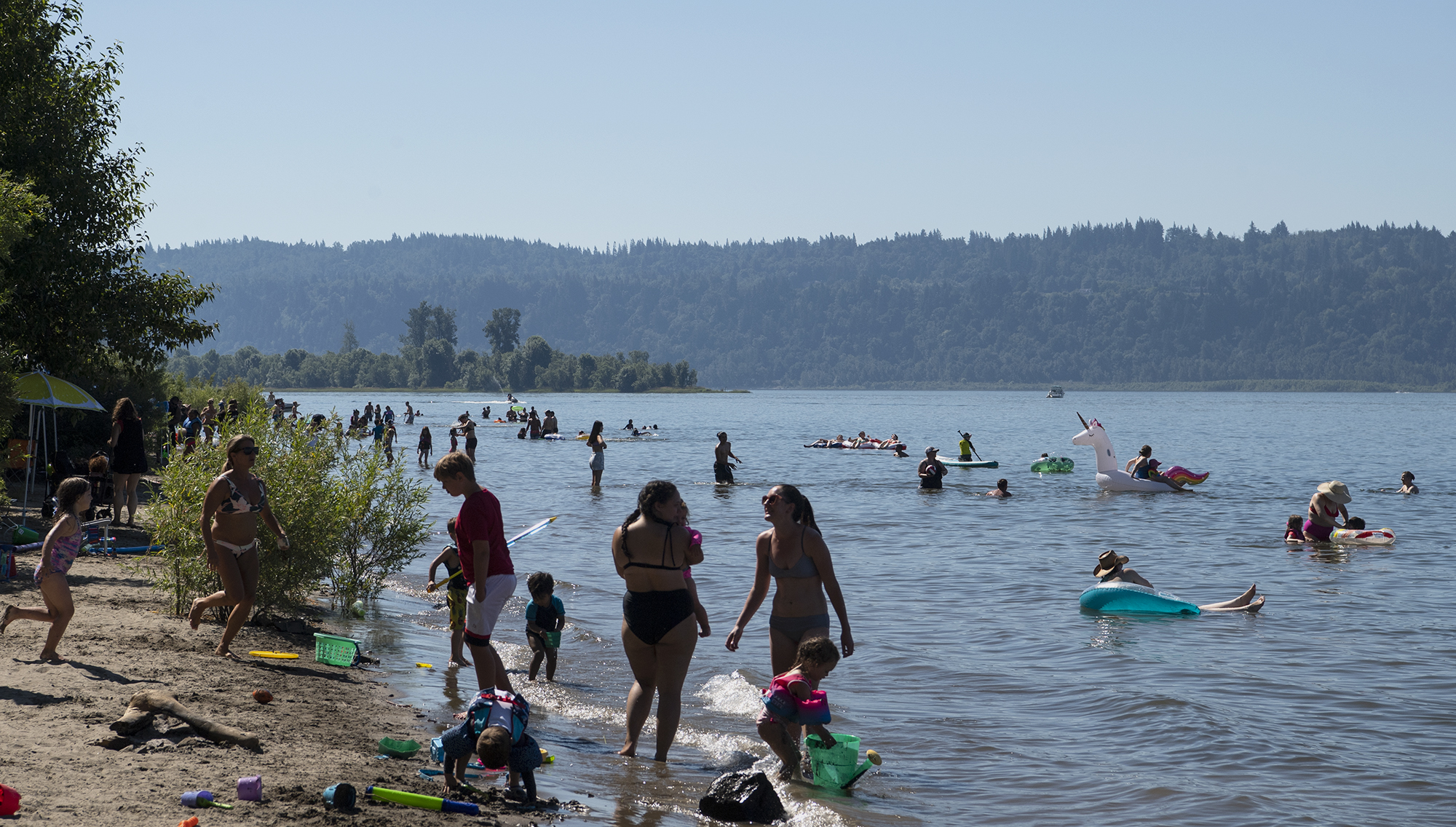 People cool off in the Columbia River on Saturday, June 26, at Cottonwood Beach in Washougal. Temperatures climbed into triple digits on Saturday, the first of three days it is expected to do so.