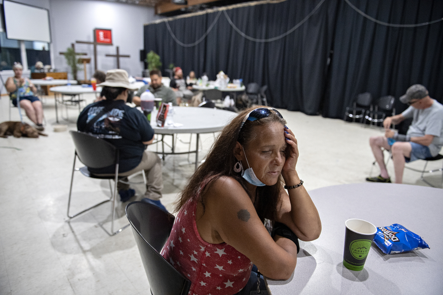 Tracy Jones of Vancouver joins a crowd of local residents at the Living Hope Church cooling center as she escapes the extreme heat on Monday afternoon. The church offered fans, cold drinks, popsicles and snacks. "I'm glad they have something like this. It's rough out there," she said.