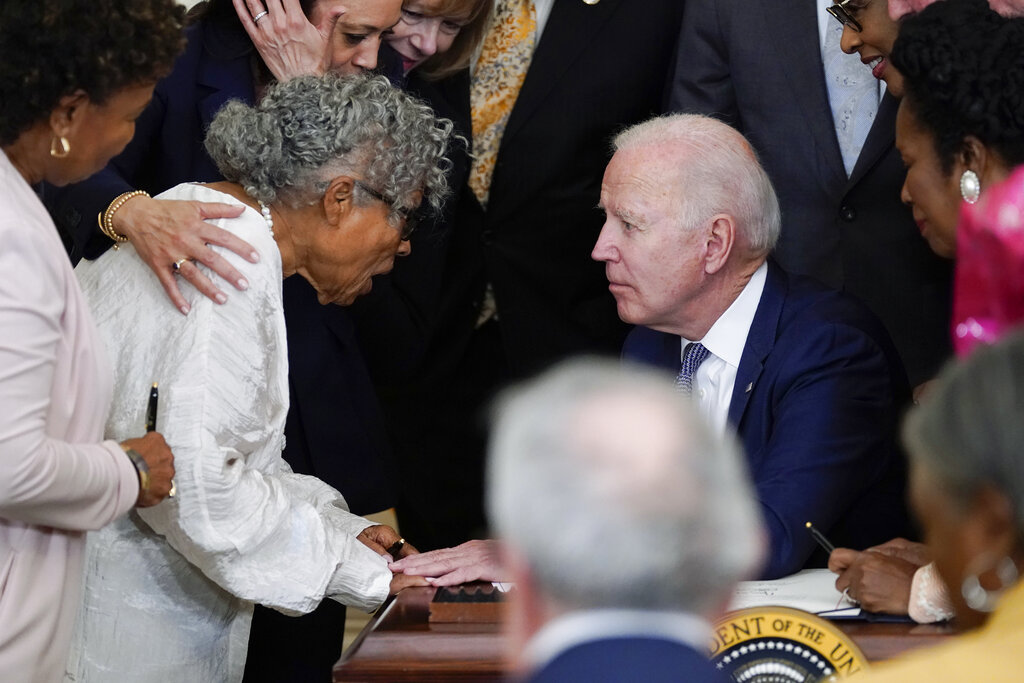 President Joe Biden speaks with Opal Lee after he signed the Juneteenth National Independence Day Act, in the East Room of the White House, Thursday, June 17, 2021, in Washington.