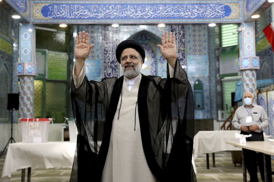 Ebrahim Raisi, a candidate in Iran's presidential elections waves to the media after casting his vote at a polling station in Tehran, Iran Friday, June 18, 2021. Iran began voting Friday in a presidential election tipped in the favor of a hard-line protege of Supreme Leader Ayatollah Ali Khamenei, fueling public apathy and sparking calls for a boycott in the Islamic Republic.
