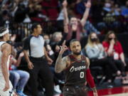 Portland Trail Blazers guard Damian Lillard reacts after making a 3-point basket against the Denver Nuggets during the first half of Game 6 of an NBA basketball first-round playoff series Thursday, June 3, 2021, in Portland, Ore.