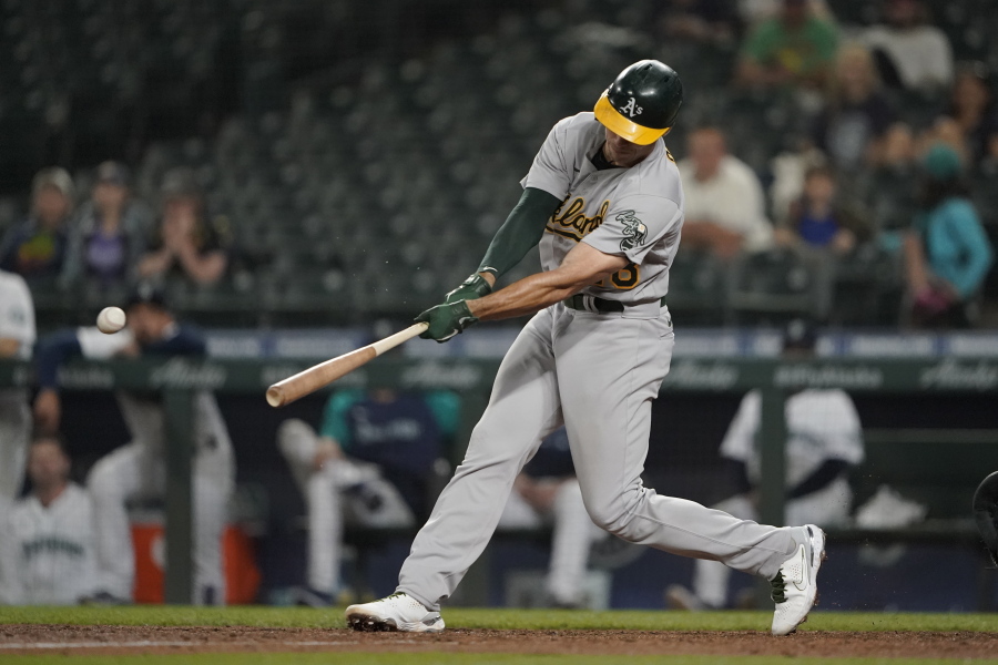 Oakland Athletics' Matt Olson hits a two-run single during the seventh inning of the team's baseball game against the Seattle Mariners, Tuesday, June 1, 2021, in Seattle. (AP Photo/Ted S.