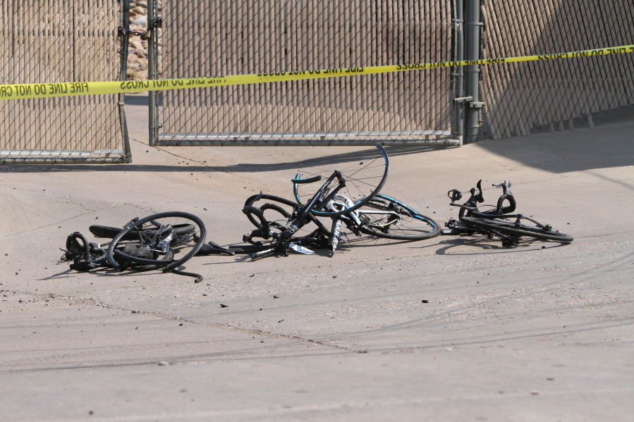 This Saturday, June 19, 2021, photo courtesy of The White Mountain Independent shows the scene of an accident with broken bicycles in Show Low, Ariz. A driver in a pickup truck plowed into bicyclists competing in a community road race in Arizona on Saturday, critically injuring several riders before police chased down the driver and shot him outside a nearby hardware store, police said.