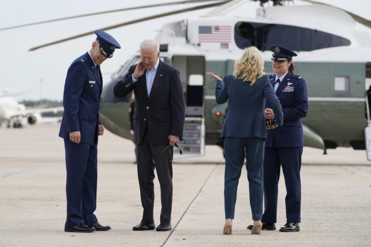 President Joe Biden brushes a cicada from his neck as he and first lady Jill Biden board Air Force One, Wednesday, June 9, 2021, at Andrews Air Force Base, Md. Biden is embarking on the first overseas trip of his term, and is eager to reassert the United States on the world stage, steadying European allies deeply shaken by his predecessor and pushing democracy as the only bulwark to the rising forces of authoritarianism.