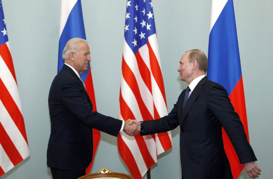 FILE - In this March 10, 2011 file photo, then U.S. Vice President Joe Biden, left, shakes hands with Russian Prime Minister Vladimir Putin in Moscow.  Biden likes to say foreign policy is about building personal relationships. But unlike his three most recent White House predecessors, who all tried and failed to build a rapport with Vladimir Putin, Biden over the years in public and private comments has demonstrated that the virtue of personal diplomacy might have its limits when it comes to the Russian leader.