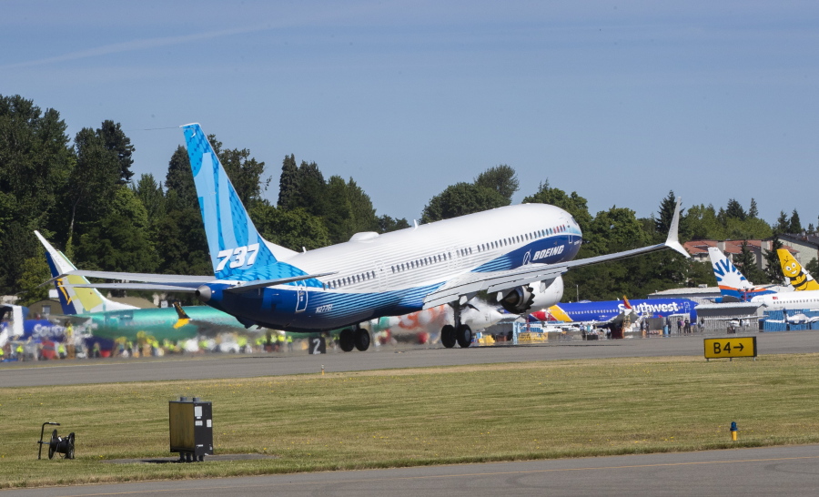 The final version of the 737 MAX, the MAX 10, passes other 737 MAX planes as it takes off from Renton Airport in Renton, Wash., on its first flight Friday, June 18, 2021. The plane will fly over Eastern Washington and then land at Boeing Field.  (Ellen M.