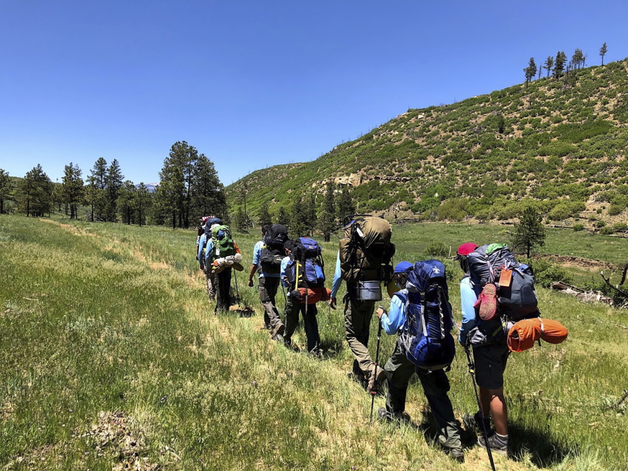 In this June 10, 2021 photo provided by Barry Bedlan, members of Troop 298 of Frisco, Texas are among the first to embark a 12-day trek across the Philmont Scout Ranch, outside Cimarron, N.M. Boy Scout and Girl Scouts' leadership say their summer camps are full, special events are sold out, and they're expecting many thousands of families - some new to scouting, some who left during the pandemic - to sign up now that activities are occurring in-person rather than virtually.