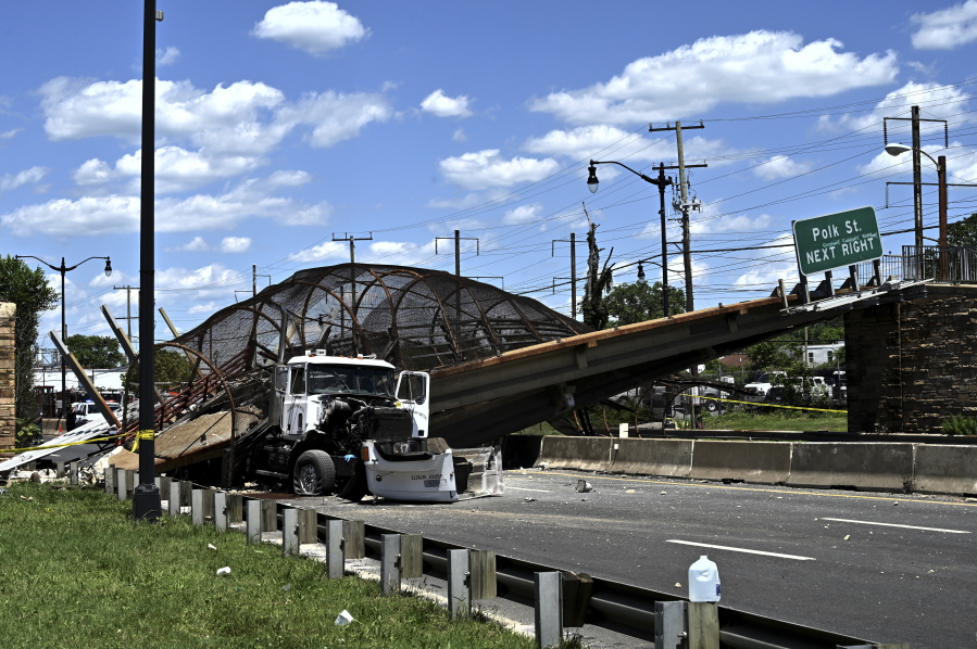 A truck sits under a collapsed pedestrian bridge along Kenilworth Avenue & Polk Street Northeast in Washington, Wednesday, June 23, 2021.