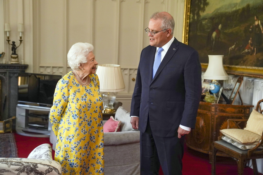 Britain's Queen Elizabeth II, left receives Australian Prime Minister Scott Morrison during an audience in the Oak Room at Windsor Castle, in Windsor, England, Tuesday June 15, 2021.
