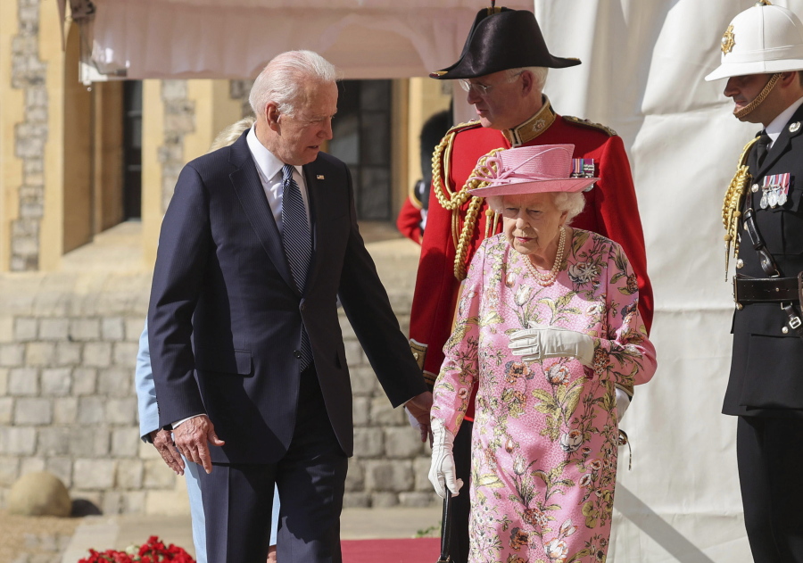 Britain's Queen Elizabeth II, right, walks with US President Joe Biden during his visit to Windsor Castle, near London, Sunday June 13, 2021.