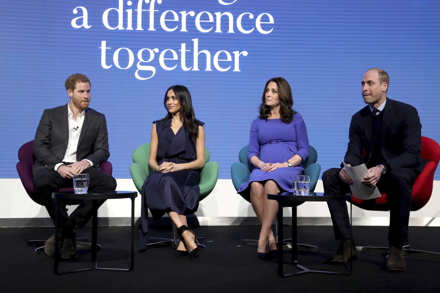 FILE - In this file photo dated Wednesday Feb. 28, 2018, Britain's Prince William and Kate, Duchess of Cambridge, right, sit with Prince Harry, left, and his fiancee Meghan Markle, as they attend the first annual Royal Foundation Forum in London. Under the theme 'Making a Difference Together', the event will showcase programmes run or initiated by The Royal Foundation.  Links now seem strained between the brothers as William sits in London defending the royal family from allegations of racism and insensitivity.