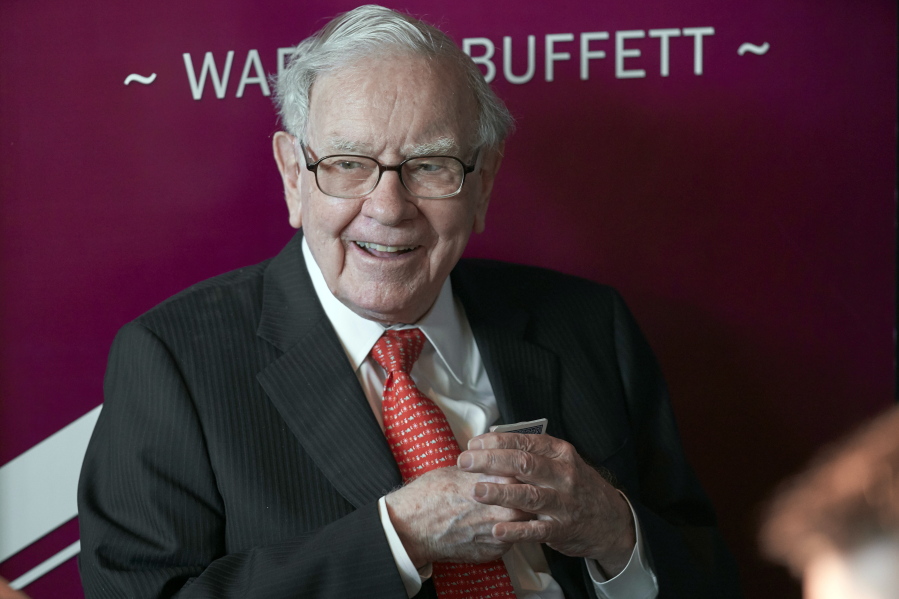 FILE - In this May 5, 2019, file photo Warren Buffett, Chairman and CEO of Berkshire Hathaway, smiles as he plays bridge following the annual Berkshire Hathaway shareholders meeting in Omaha, Neb. Warren Buffett made a $4.1 billion annual philanthropic contribution and said he's halfway through his goal of giving away most of his money. The billionaire investor also said he is stepping down as trustee of the Bill and Melinda Gates Foundation as he exits all other corporate boards.