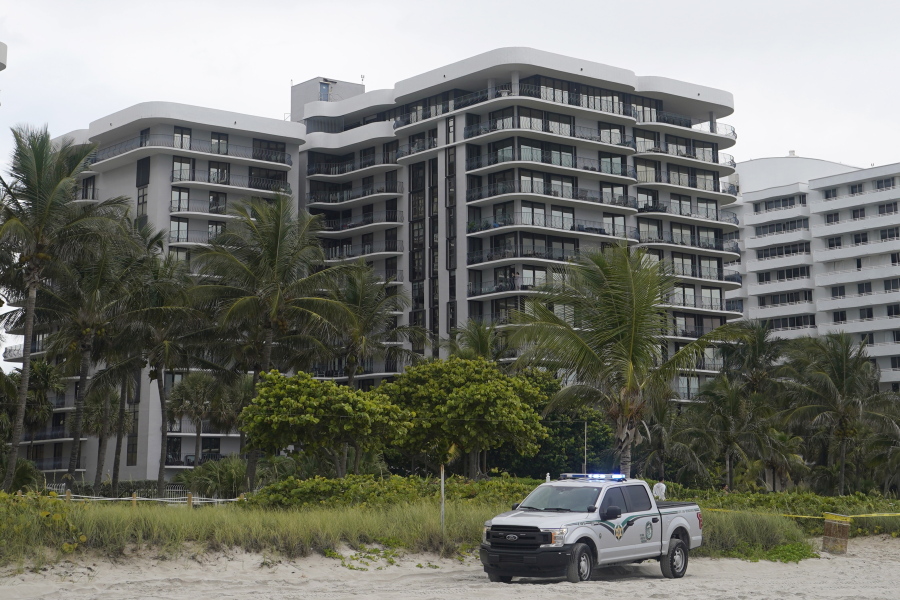 FILE - This Thursday, June 24, 2021, file photo, shows a sister building of a condominium that partially collapsed earlier the same day, in Surfside, Fla. This building, erected a year later by the same company, using the same materials and a similar design, has faced the same tides and salty air as the building that collapsed.