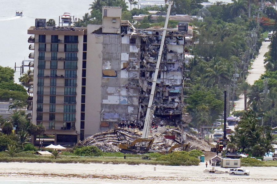 Workers search in the rubble at the Champlain Towers South Condo, Saturday, June 26, 2021, in Surfside, Fla. One hundred fifty-nine people were still unaccounted for two days after Thursday's collapse, which killed at least four.