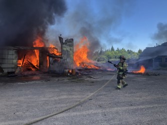 Clark-Cowlitz Fire Rescue crews battle a barn fire Wednesday afternoon at 23115 N.W. Hillhurst Road in Ridgefield. No one was injured. The barn, once part of Kennedy dairy farm, was being demolished to make way for the Kennedy Farm housing development.