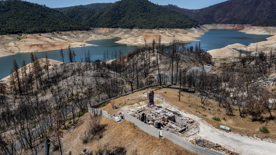 A home destroyed in the 2020 North Complex Fire sits above Lake Oroville on Sunday, May 23, 2021, in Oroville, Calif. At the time of this photo, the reservoir was at 39 percent of capacity and 46 percent of its historical average. California officials say the drought gripping the U.S. West is so severe it could cause one of the state's most important reservoirs to reach historic lows by late August, closing most boat ramps and shutting down a hydroelectric power plant during the peak demand of the hottest part of the summer.
