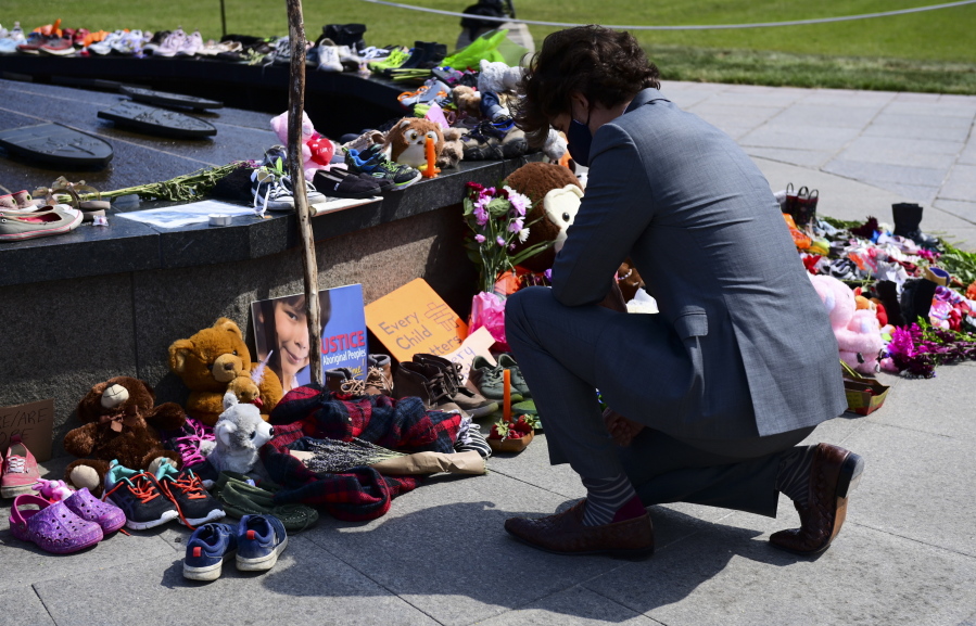 FILE - In this June 1, 2021, file photo, Canadian Prime Minister Justin Trudeau visits a memorial at the Eternal Flame on Parliament Hill in Ottawa that's in recognition of discovery of children's remains at the site of a former residential school in Kamloops, British Columbia. Leaders of Indigenous groups in Canada say investigators have found more than 600 unmarked graves at the site of a former residential school for Indigenous children in Saskatchewan. That follows last month's discovery of about 215 bodies at another such school in British Columbia.