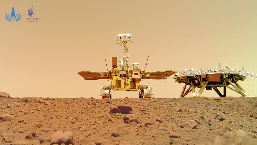 In this image released by the China National Space Administration (CNSA) on Friday, June 11, 2021, the Chinese Mars rover Zhurong is seen near its landing platform taken by a remote camera that was dropped into position by the rover. China on Friday released a series of photos taken by its Zhurong rover on the surface of Mars, including one of the rover itself taken by a remote camera.