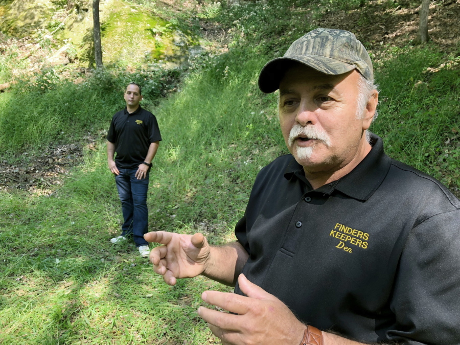 FILE - This Sept. 20, 2018, file photo, Dennis Parada, right, and his son Kem Parada stand at the site of the FBI's dig for Civil War-era gold in Dents Run, Pa. Court documents unsealed Thursday, June 24, 2021, show that an FBI agent applied for a federal warrant in 2018 to seize a cache of gold that he said had been "stolen during the Civil War" while en route to the U.S. Mint in Philadelphia. The Paradas, co-owners of the treasure-hunting outfit Finders Keepers, have said they believe the FBI found gold at the site and have pursued legal action to get more information.