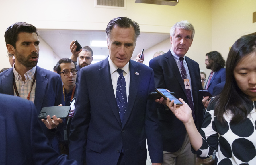 Sen. Mitt Romney, R-Utah, is surrounded by reporters as he walks to the Senate chamber for votes, at the Capitol in Washington, Thursday, June 10, 2021. Sen. Romney is working with a bipartisan group of 10 senators negotiating an infrastructure deal with President Joe Biden. (AP Photo/J.