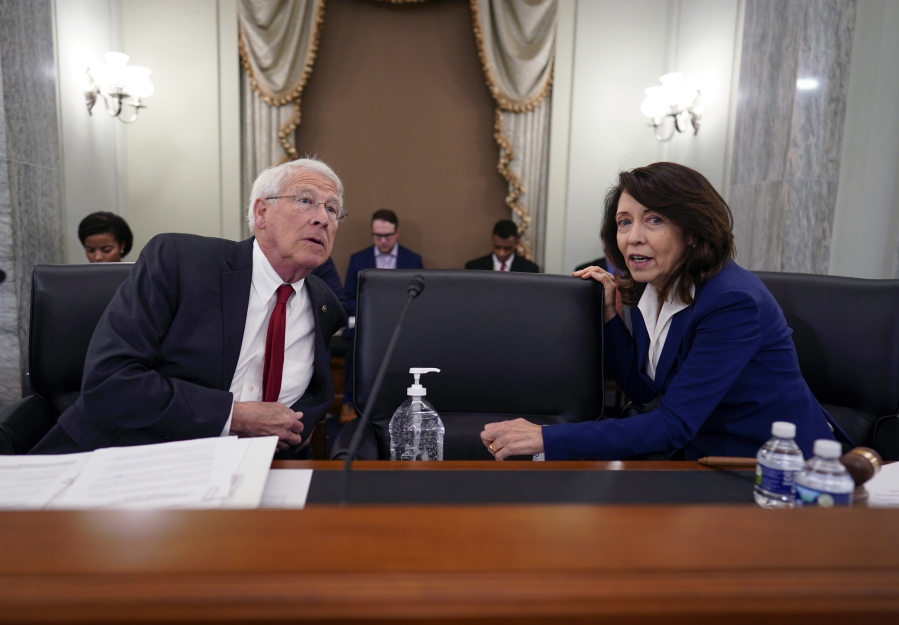 Sen. Roger Wicker, R-Miss., left, and Sen. Maria Cantwell, D-Wash., chair of the Senate Commerce, Science, and Transportation Committee, prepare to hold a hearing on student athlete compensation and federal legislative proposals to enable athletes participating in collegiate sports to monetize their name, image, and likeness, at the Capitol in Washington, Wednesday, June 9, 2021. (AP Photo/J.