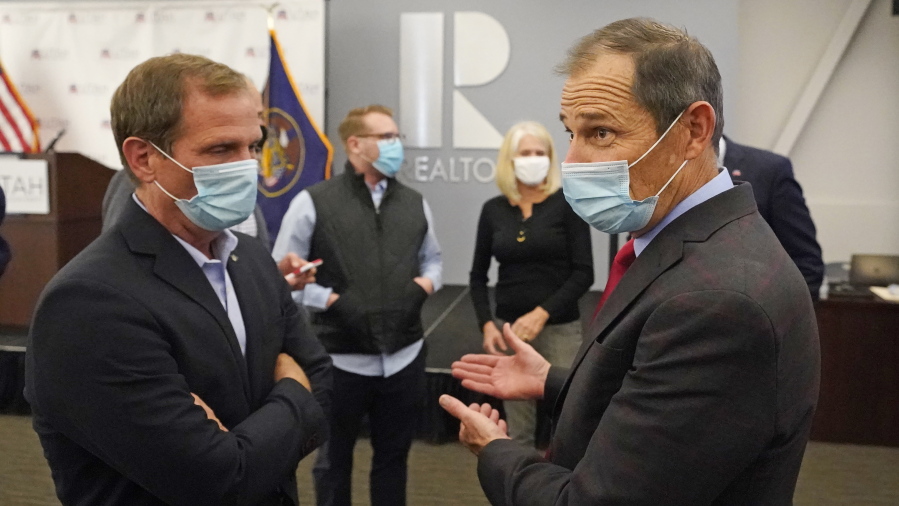 FILE - In this Nov. 3, 2020, file photo, Republican Reps. Chris Stewart, left, and John Curtis talk during an Utah Republican election night party in Sandy, Utah. Curtis is leading a new Conservative Climate Caucus for House Republicans.