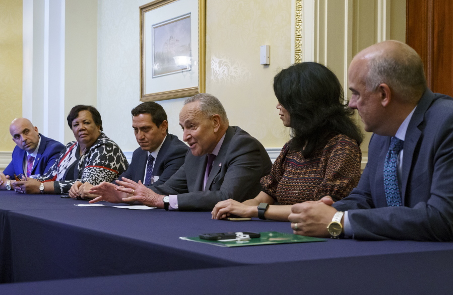 Senate Majority Leader Chuck Schumer, D-N.Y., is flanked by Texas Rep. Trey Martinez Fischer of San Antonio, left, and Texas Sen. Carol Alvarado of Houston, as he meets with Texas Democratic lawmakers to discuss voting rights, at the Capitol in Washington, Tuesday, June 15, 2021. Two weeks ago the Democrats walked out of the Texas House of Representatives to block passage of a new restrictive voting law. (AP Photo/J.