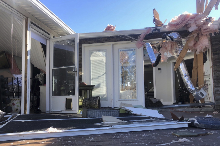 Damage scatters the rear of Tim Long's home in Ocean Isle Beach, N.C., Feb. 16, 2021, following a tornado that struck the area the previous night. The twister that hit Ocean Isle Beach in February killed three people and injured about 10 others.