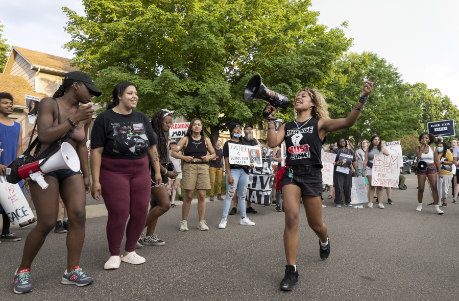 Protesters demonstrate outside of the home of U.S. Marshal Ramona Dohman, Tuesday, June 8, 2021, in Minneapolis, in protest of the fatal shooting of Winston Boogie Smith Jr., the week before. The two sheriff's deputies who shot and killed Smith while assigned to a U.S. Marshals Service fugitive task force had been told they could not use their body-worn cameras. That's despite a change in Justice Department policy to allow cameras months before the shooting.