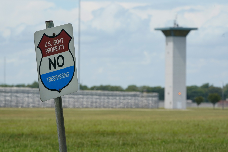 FILE - In this Aug. 28, 2020, file photo, a no trespassing sign is displayed outside the federal prison complex in Terre Haute, Ind. Over the past 18 months, 29 prisoners have escaped from federal lockups across the U.S. - and nearly half still have not been caught.