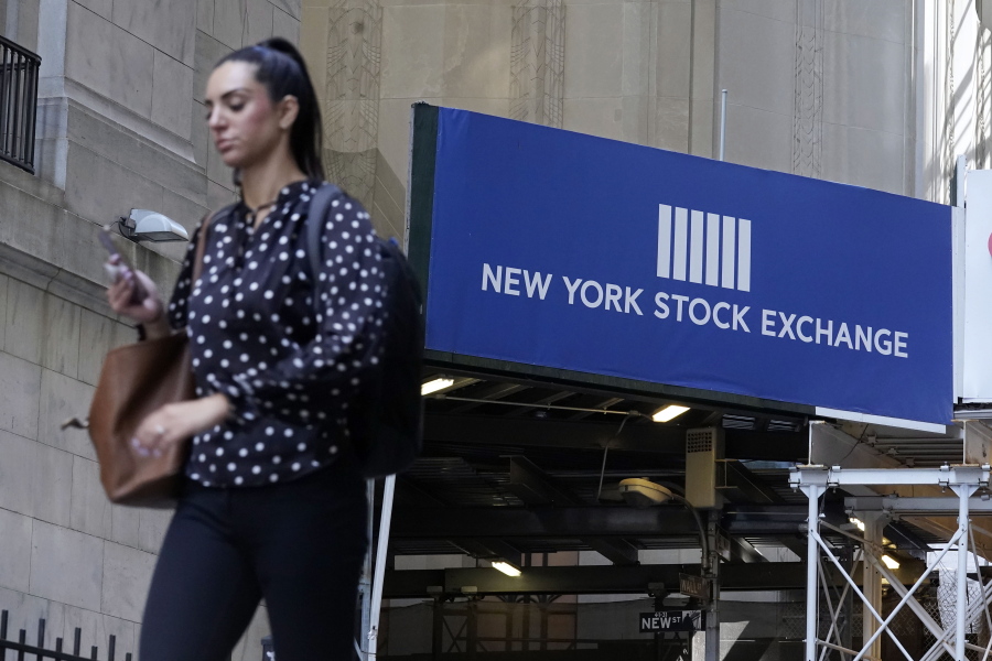 A woman passes an entrance of the New York Stock Exchange, Wednesday, June 16, 2021. Stocks are opening broadly lower on Wall Street, putting the S&P 500 index on track for its first losing week in the last four. The benchmark index gave up 0.8% in the early going Friday, June 18 with banks and technology companies leading the way lower.