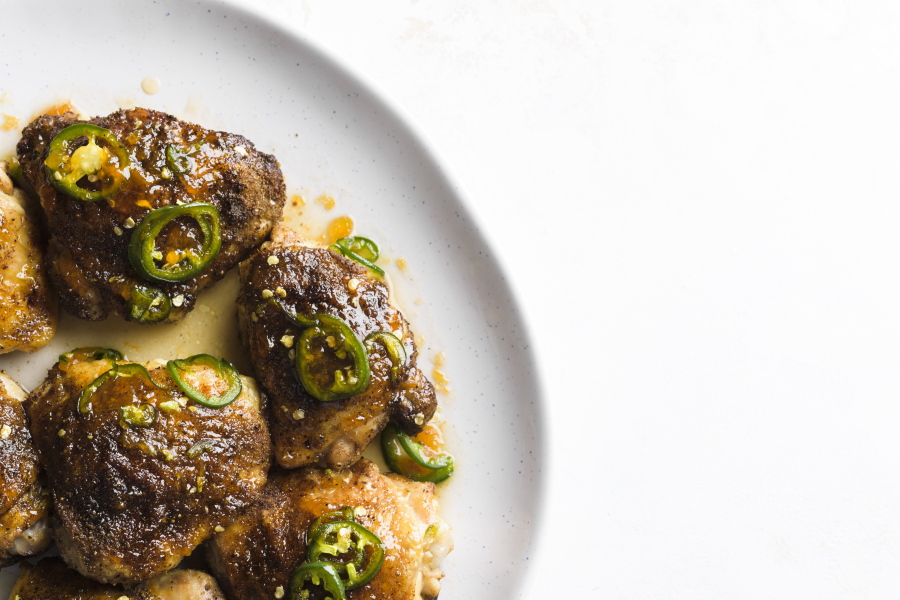 A recipe for glazed chicken thighs, seasoned with jalapenos and apricot preserves.
