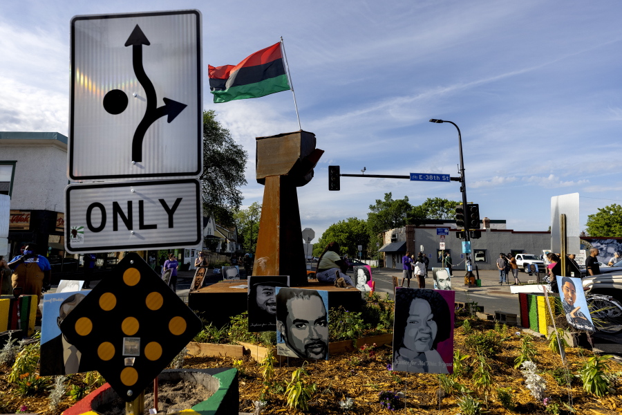 A traffic sign signals directions around the monument at George Floyd Square, Thursday, June 3, 2021, in Minneapolis. Crews are removing concrete barriers as well as artwork, flowers and other memorial items from a Minneapolis intersection that has become a sprawling memorial to George Floyd. (Crews are removing concrete barriers as well as artwork, flowers and other memorial items from a Minneapolis intersection that has become a sprawling memorial to George Floyd.