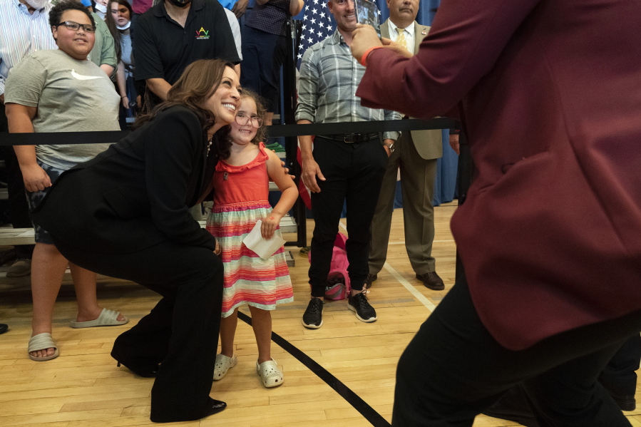 Vice President Kamala Harris leans in for a photograph with Stella Quatrini, after Harris spoke about the child tax credit at Brookline Memorial Recreation Center, Monday June 21, 2021, in Pittsburgh.