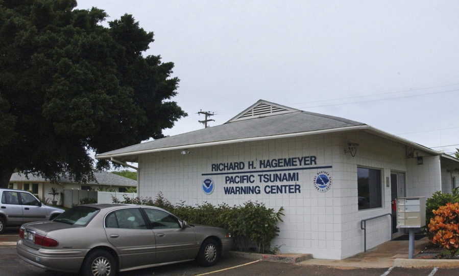 FILE - In this Dec. 30, 2004, file photo, The Pacific Tsunami Warning Center building in Ewa Beach, Hawaii, where geophysicists with the National Weather Service Pacific Tsunami Warning Center, monitor computer tracking systems watching for tsunami, or tidal wave, activity in the Pacific Ocean. The U.S. is giving Native Hawaiians surplus land as compensation for acres that were meant for homesteading but used instead by the government. Officials on Monday, June 14, 2021, said the transfer attempts to help right wrongs against the Indigenous people of Hawaii. It includes Ewa Beach land and helps fulfill terms of a settlement agreement authorized by Congress in 1995.