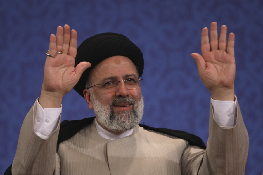 Iran's new President-elect Ebrahim Raisi waves to participants at the conclusion of his press conference in Tehran, Iran, Monday, June 21, 2021. Raisi said Monday he wouldn't meet with President Joe Biden nor negotiate over Tehran's ballistic missile program and its support of regional militias, sticking to a hard-line position following his landslide victory in last week's election.