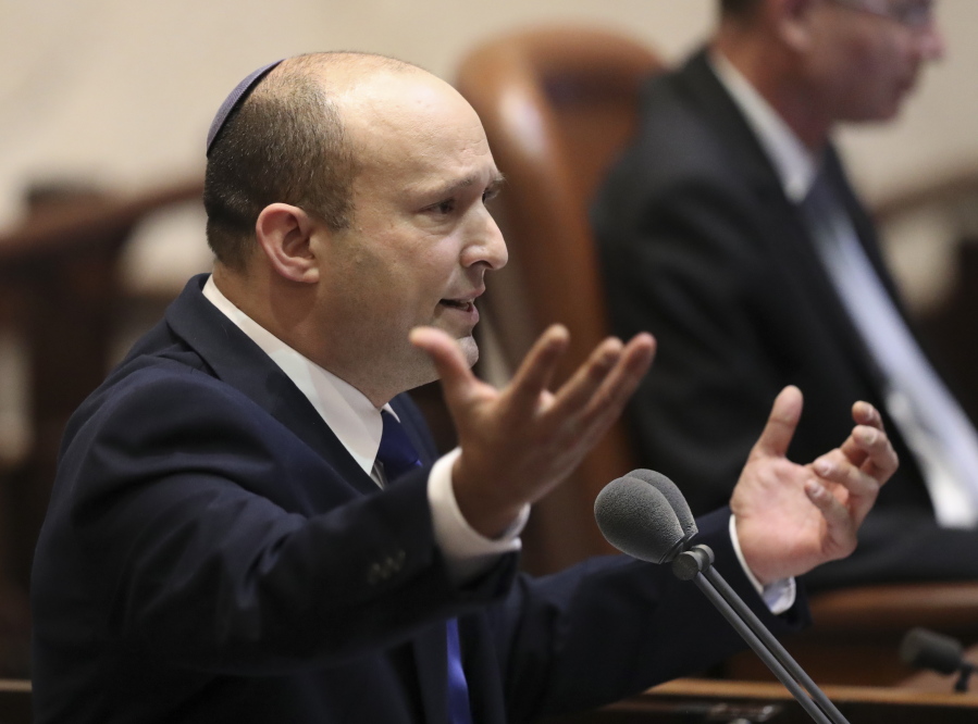 Israel's designated new prime minister, Naftali Bennett speaks during a Knesset session in Jerusalem Sunday, June 13, 2021. Bennett is expected later Sunday to be sworn in as the country's new prime minister, ending Prime Minister Benjamin Netanyahu's 12-year rule.