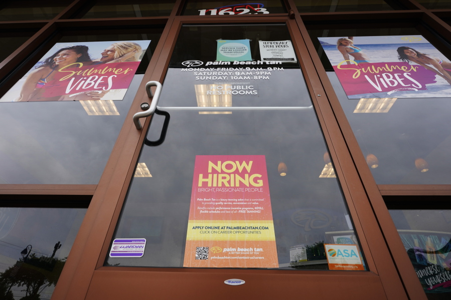 A Now Hiring sign at a business in Richmond, Va., Wednesday, June 2, 2021.  U.S. employers posted a record 9.3 million job openings in April as the U.S. economy reopens at break-neck speed. Openings were up 12 percent from 8.3 million in March.