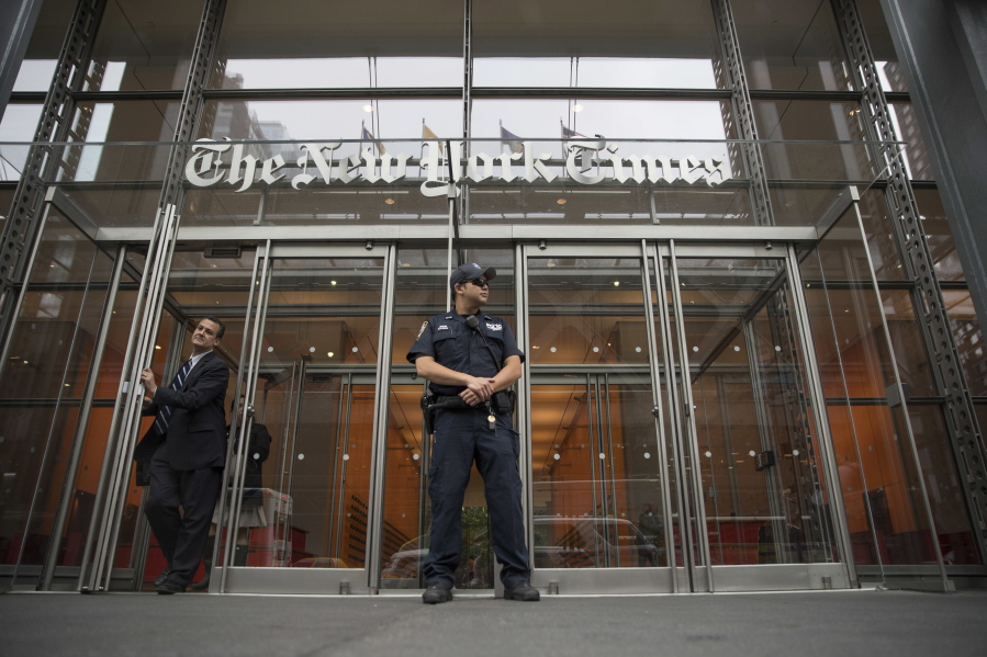 FILE - In this June 28, 2018, file photo, a police officer stands outside The New York Times building in New York. The Trump Justice Department secretly obtained the phone records of four New York Times journalists as part of a leak investigation, the newspaper said Wednesday, June 2, 2021.